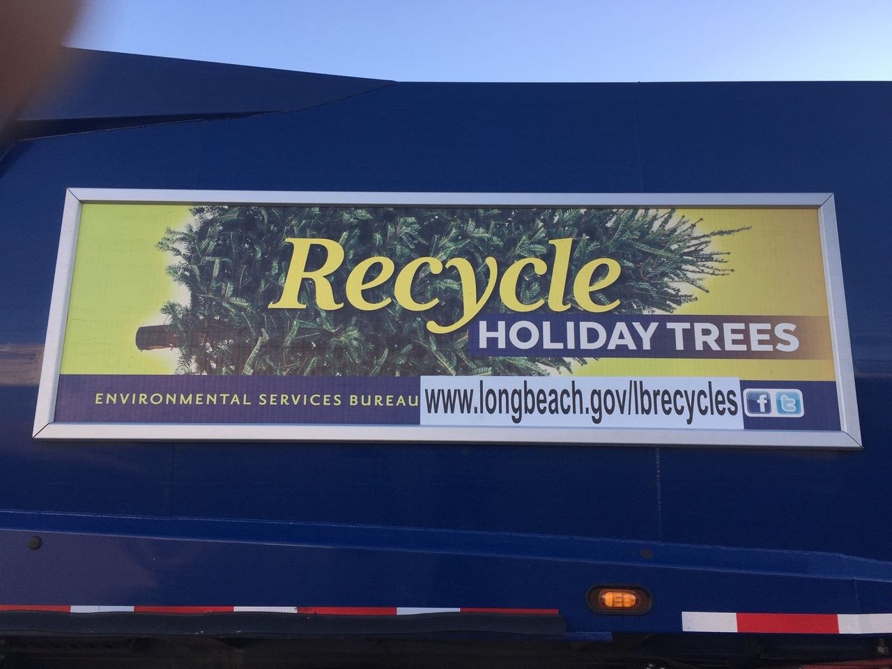 Recycle holiday trees panel in a Roadway quick-change frame on a Long Beach collection truck