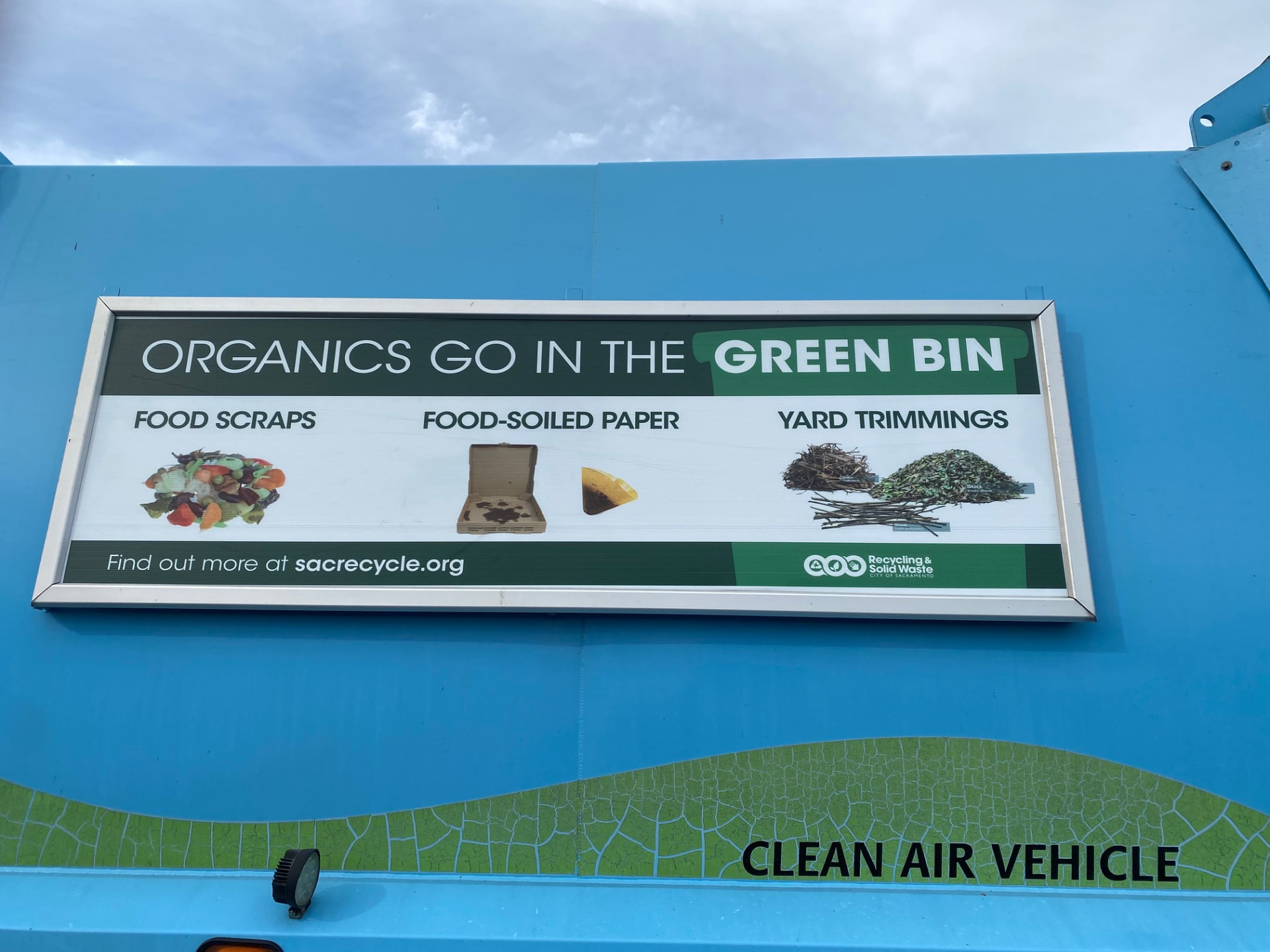 Quick-change panel on a Sacramento collection vehicle explaining what belongs in the green organics bin